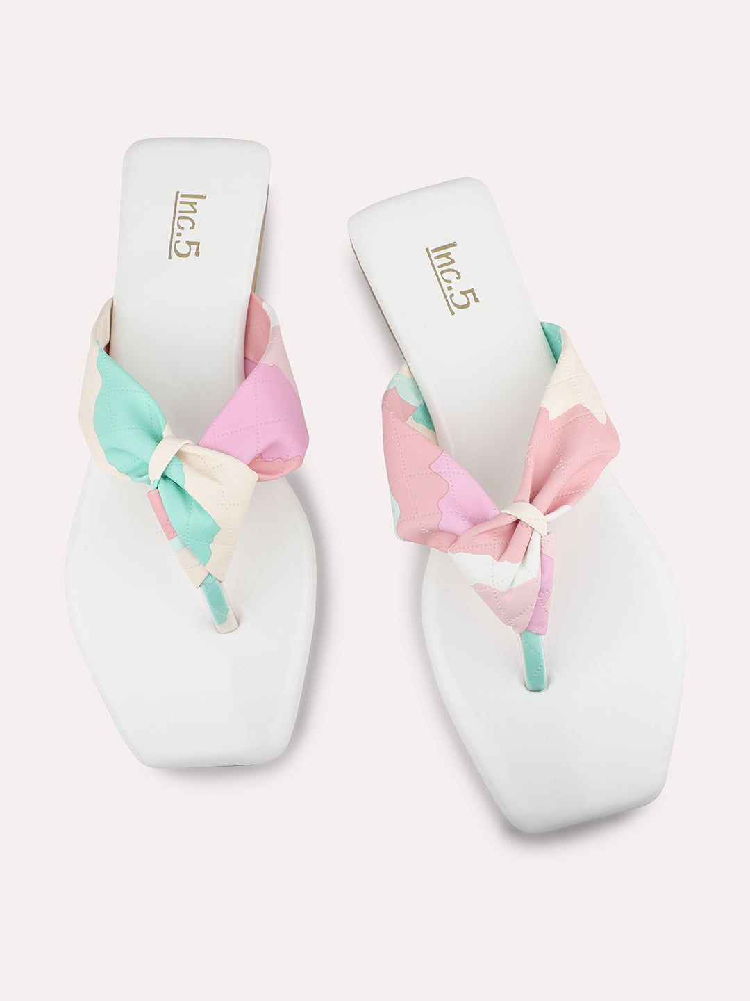 White square-toe women’s flats with colourful knot design