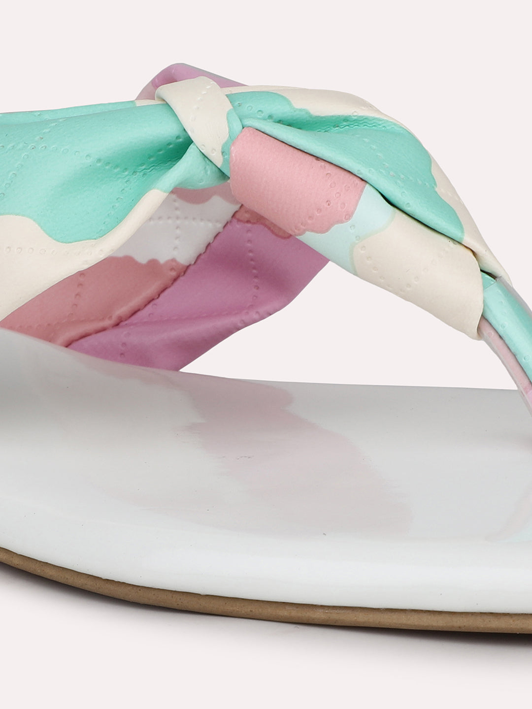 Close-up of pastel multicolour knot strap on women’s white flats by INC5